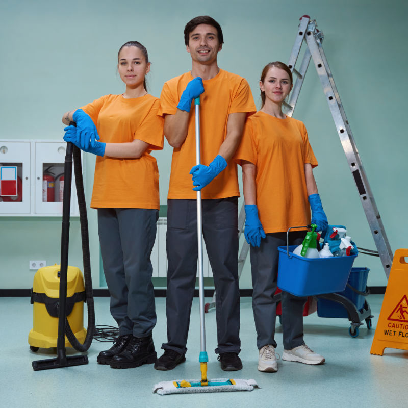 Young workers of cleaning company posing with their tools